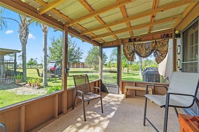 sunroom / solarium featuring vaulted ceiling