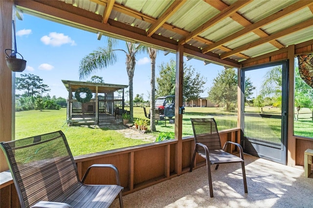 sunroom with a wealth of natural light and lofted ceiling