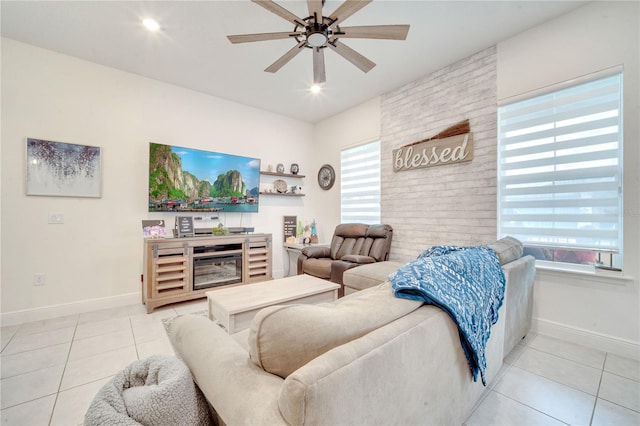 living room featuring ceiling fan, light tile patterned flooring, and a wealth of natural light