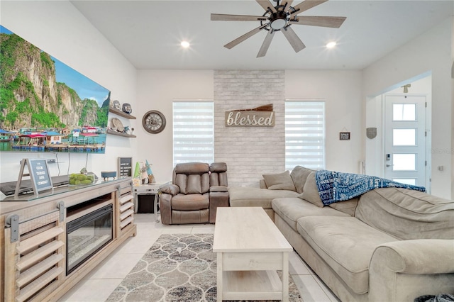 tiled living room with ceiling fan and plenty of natural light