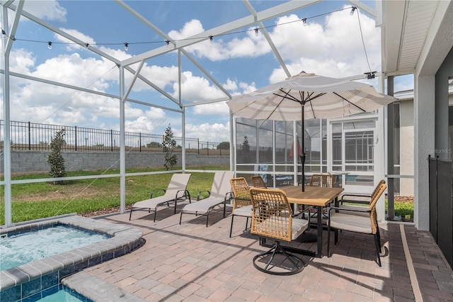 sunroom with outdoor dining area and a hot tub