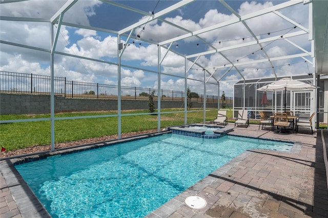 view of swimming pool with a patio area, a pool with connected hot tub, a lawn, fence, and a lanai
