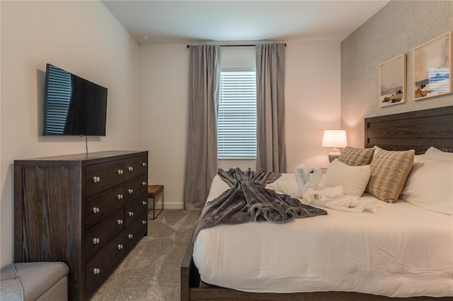 carpeted bedroom featuring baseboards