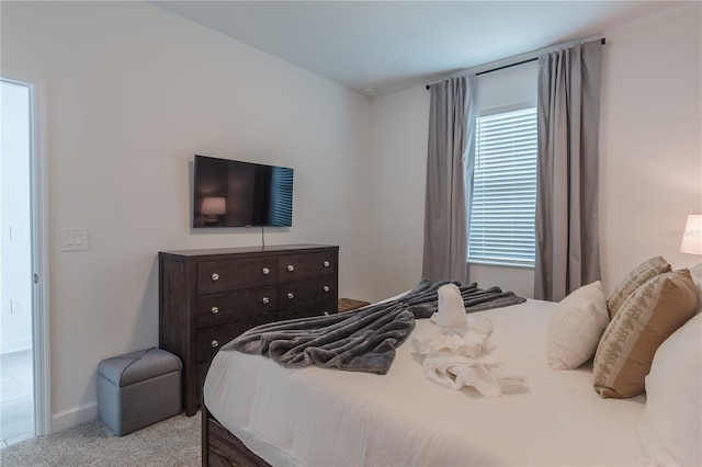 bedroom with carpet and baseboards