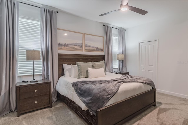 bedroom featuring baseboards, a ceiling fan, and light carpet