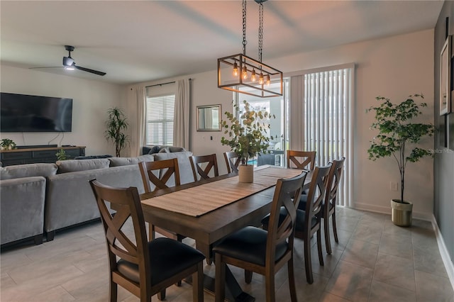 dining space featuring light tile patterned floors, baseboards, and ceiling fan