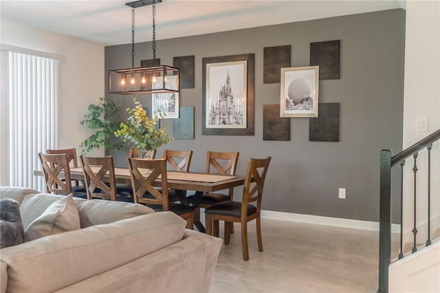 dining room with stairway, baseboards, and a healthy amount of sunlight