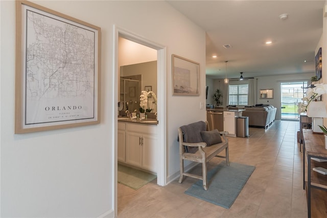 corridor featuring recessed lighting and baseboards