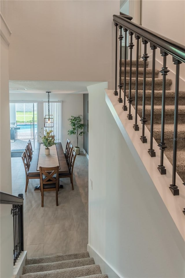 stairway with tile patterned floors