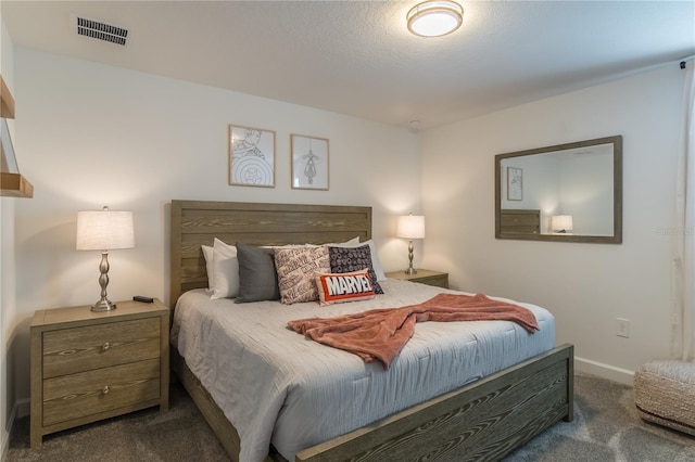 bedroom with visible vents, baseboards, and dark colored carpet