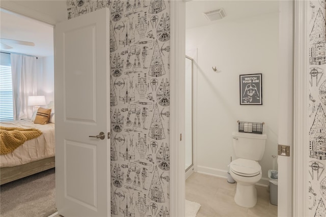 ensuite bathroom featuring toilet, a shower stall, visible vents, and connected bathroom