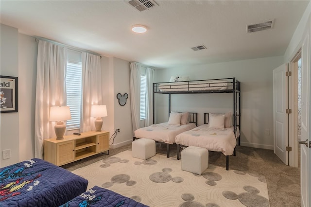 carpeted bedroom with baseboards and visible vents