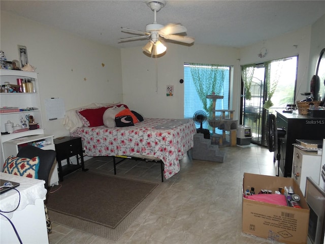 bedroom with a textured ceiling and ceiling fan