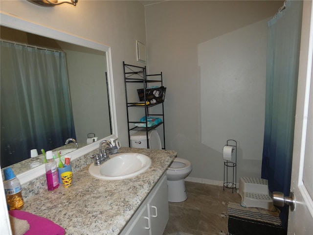 bathroom with vanity, tile patterned flooring, and toilet