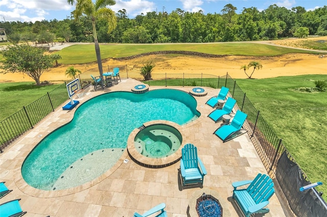 view of swimming pool with an in ground hot tub, a patio area, and a lawn