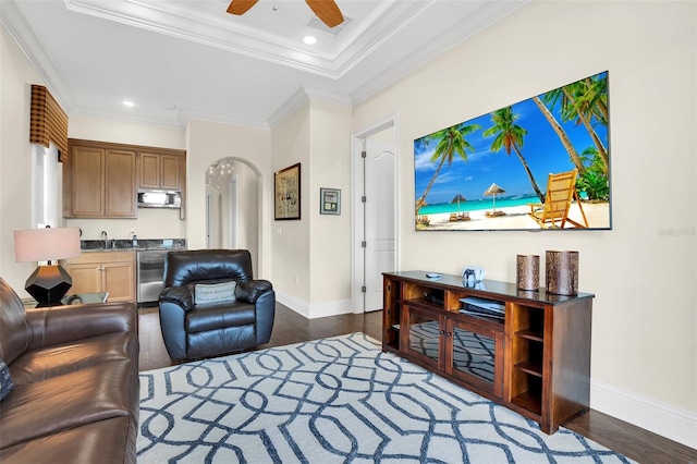 living room with ceiling fan, sink, crown molding, and dark hardwood / wood-style flooring