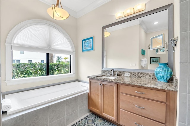 bathroom featuring ornamental molding, tiled tub, and vanity