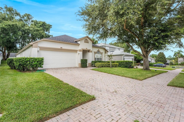 view of front of home featuring a front yard and a garage