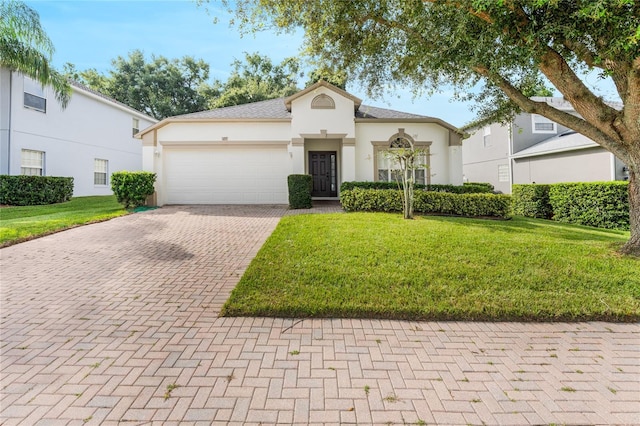 view of front of home with a front yard and a garage