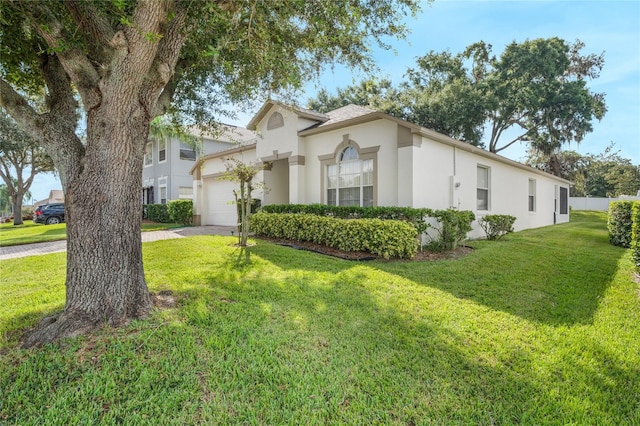 view of front of property featuring a garage and a front lawn