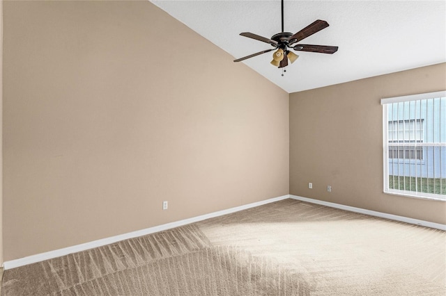 carpeted spare room with ceiling fan and lofted ceiling