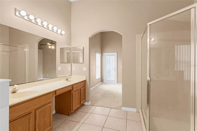 bathroom featuring tile patterned flooring, vanity, ceiling fan, and an enclosed shower