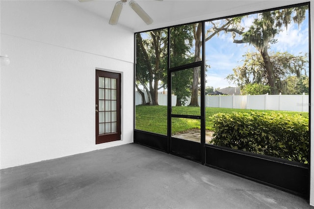 unfurnished sunroom featuring ceiling fan