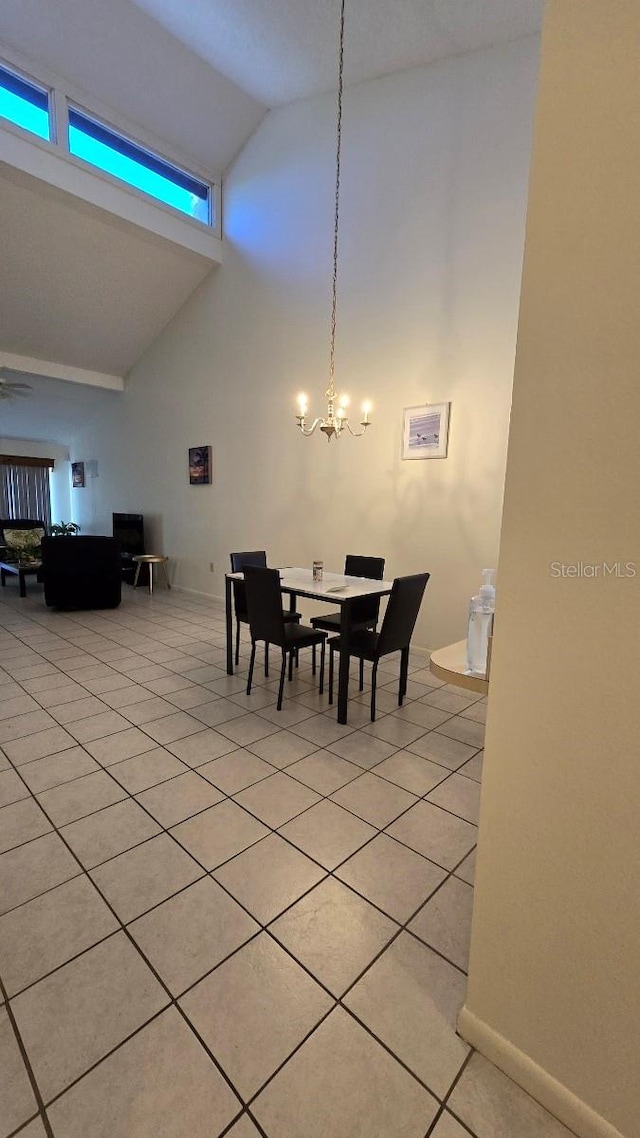 tiled dining space with a notable chandelier and high vaulted ceiling