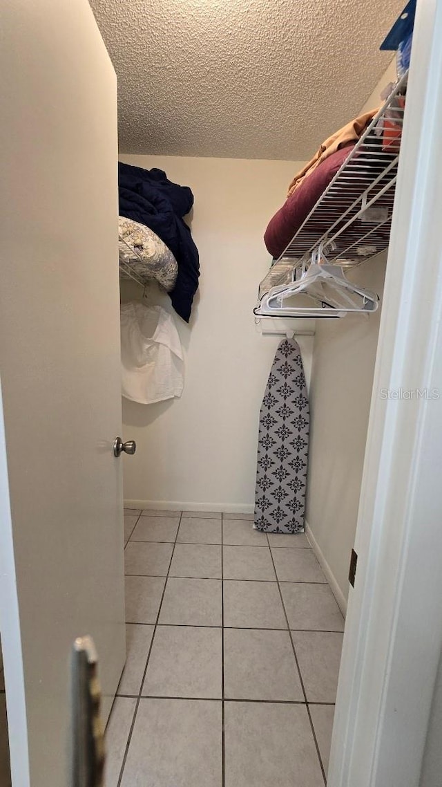 spacious closet featuring light tile patterned floors