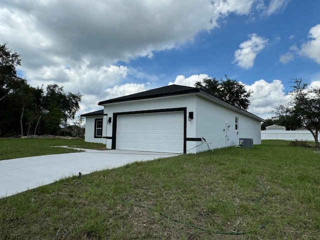 6895 SW 130th Ln, Ocala, FL 34473 - view of side of property featuring central air condition unit, stucco siding, concrete driveway, and a garage