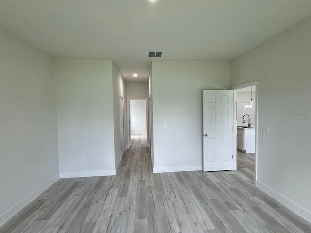 6895 SW 130th Ln, Ocala, FL 34473 - spare room with light wood-style floors, baseboards, recessed lighting, and a sink