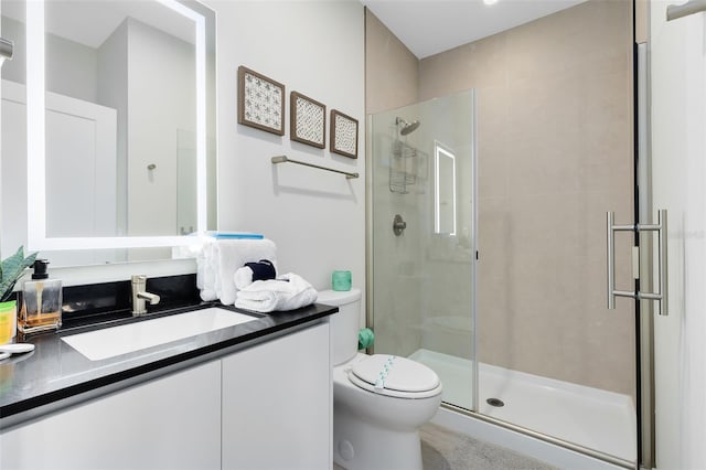 bathroom featuring vanity, toilet, and an enclosed shower