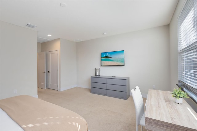 bedroom featuring a closet and light colored carpet