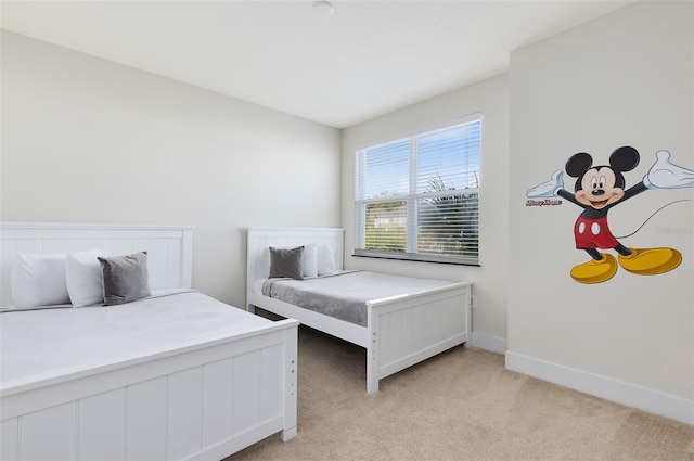 bedroom featuring light colored carpet