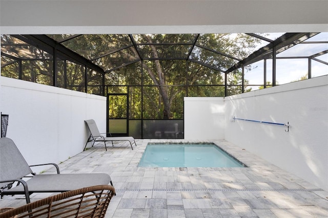 view of swimming pool with a patio and a lanai