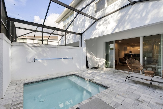 view of swimming pool with glass enclosure and a patio area