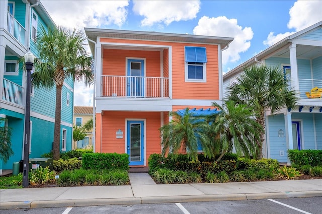 beach home featuring a balcony and central AC