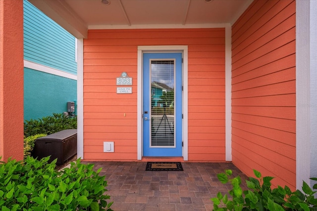 view of exterior entry featuring a patio