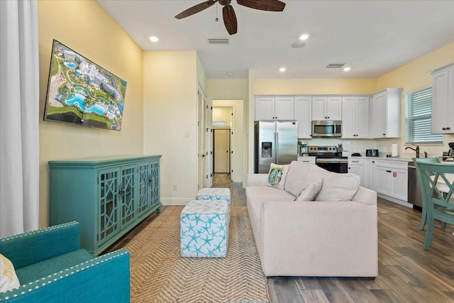 living room featuring ceiling fan and hardwood / wood-style floors