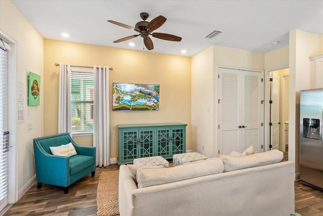 living room featuring dark hardwood / wood-style floors and ceiling fan