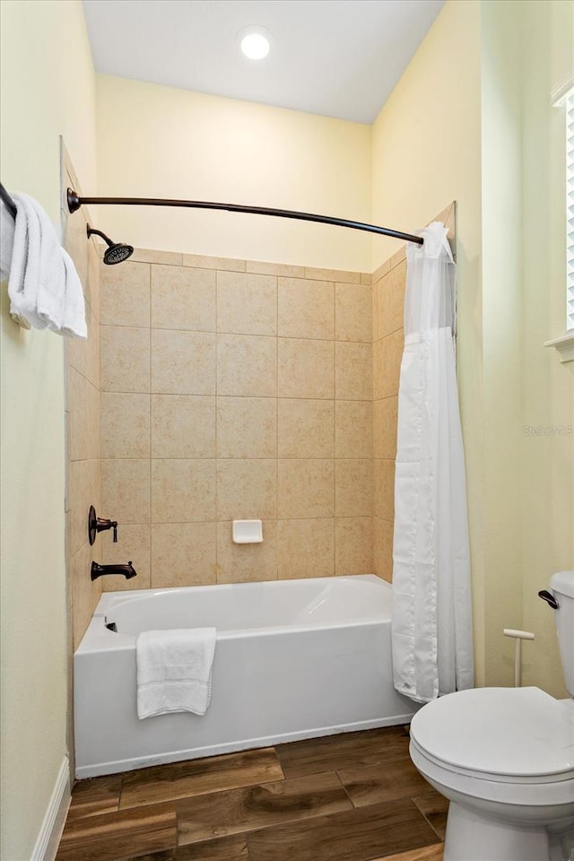 bathroom with shower / bath combination with curtain, toilet, and hardwood / wood-style floors