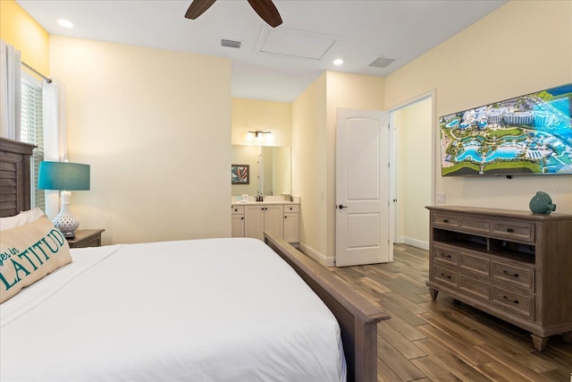 bedroom with ceiling fan, connected bathroom, and dark hardwood / wood-style flooring