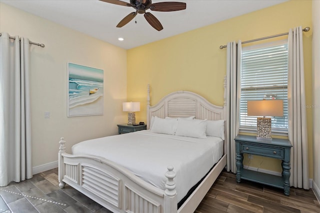 bedroom with dark hardwood / wood-style flooring and ceiling fan