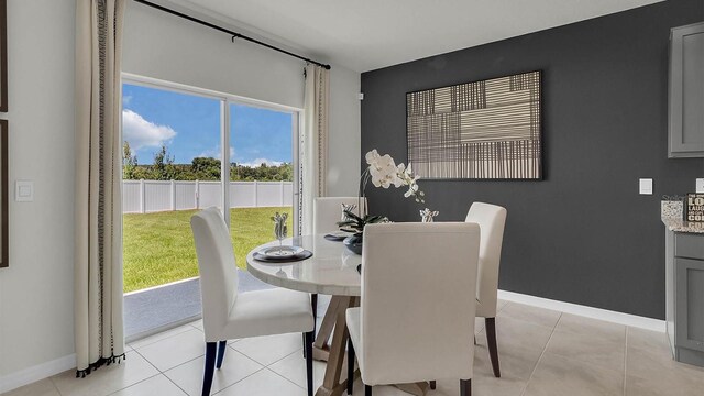 dining area with light tile patterned floors and a wealth of natural light