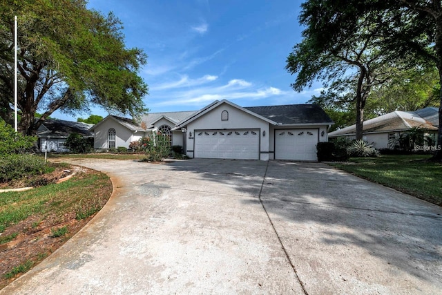 single story home featuring a front yard and a garage