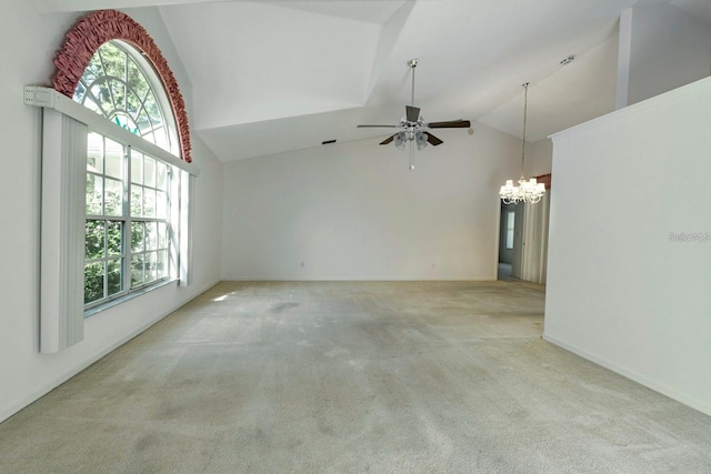 unfurnished living room featuring light carpet, ceiling fan with notable chandelier, and a healthy amount of sunlight