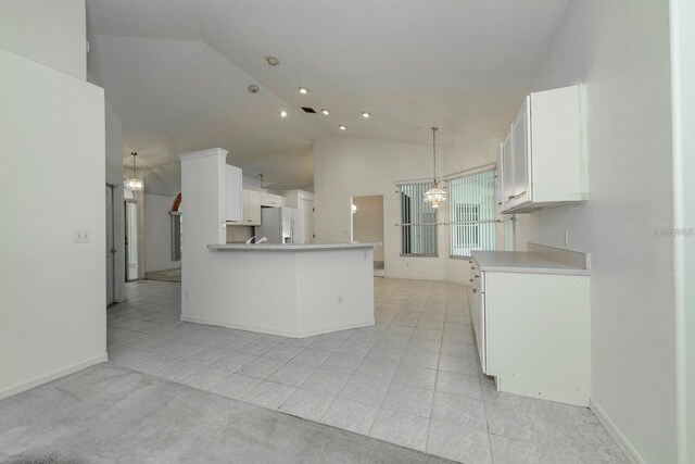 2717 Bayview Dr, Eustis, FL 32726 - kitchen with white fridge with ice dispenser, light tile patterned flooring, white cabinetry, a peninsula, and recessed lighting