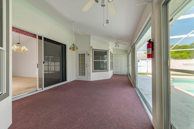 unfurnished sunroom with ceiling fan with notable chandelier