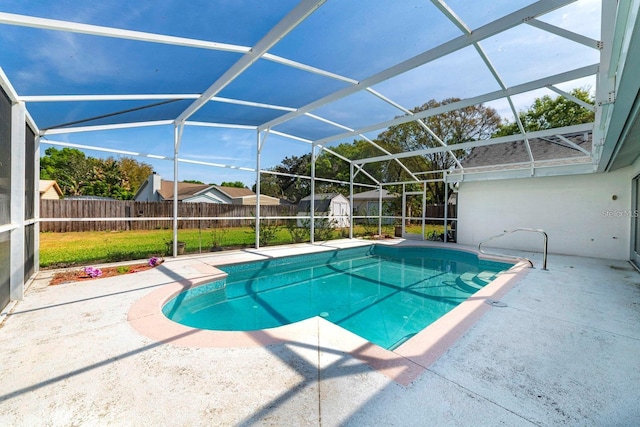 view of pool with a storage unit, a lanai, and a patio area