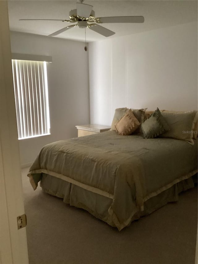 2717 Bayview Dr, Eustis, FL 32726 - carpeted bedroom featuring a ceiling fan and multiple windows
